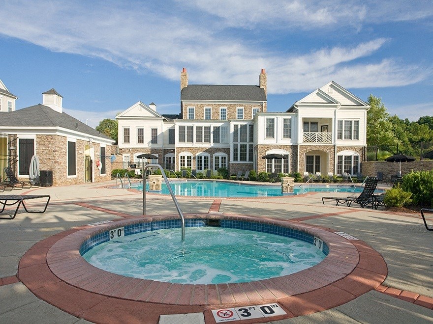 a hot tub with a fountain in front of a large house  at Harper's Crossing, Langhorne, 19047