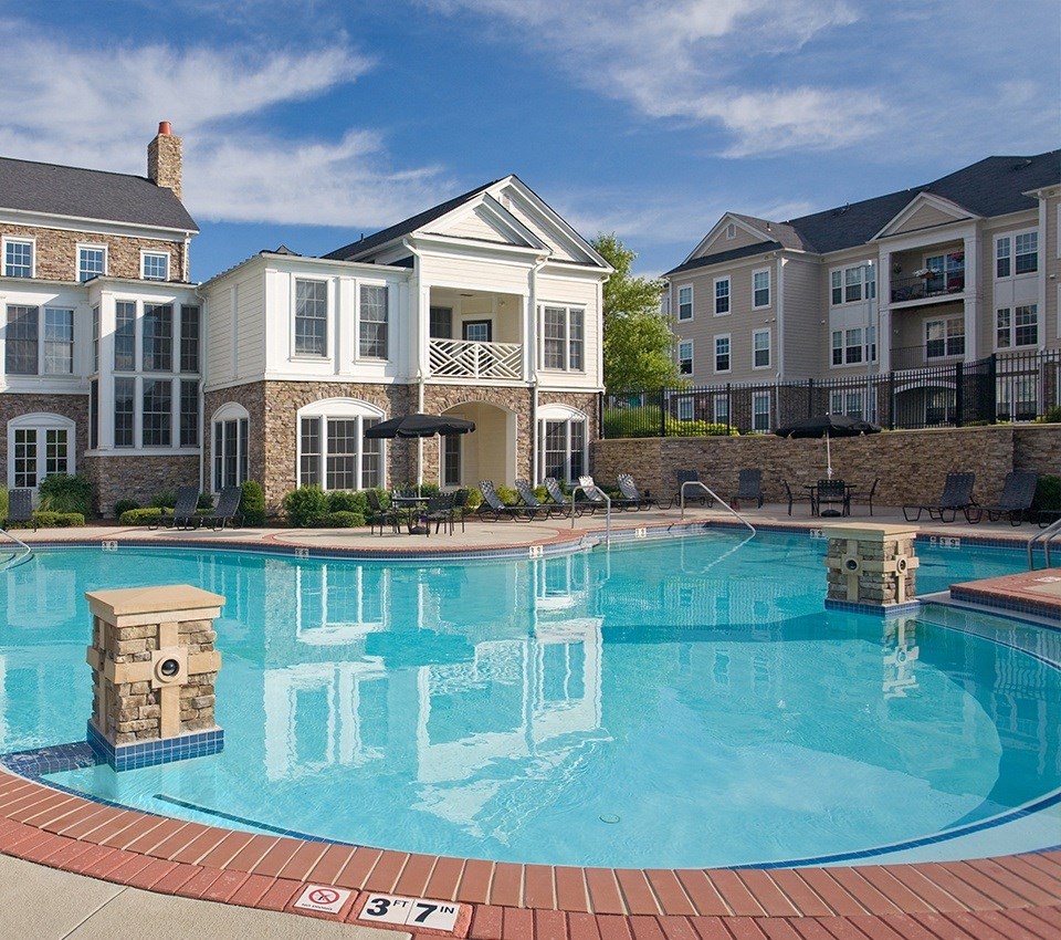 a swimming pool in front of an apartment building  at Harper's Crossing, Langhorne, PA, 19047