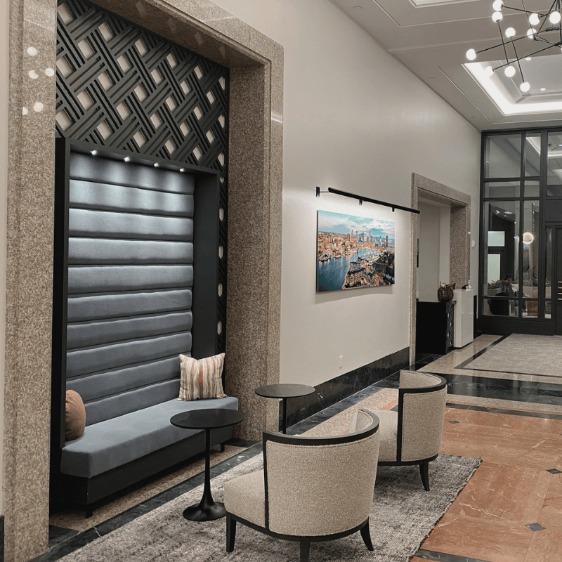 a lobby with chairs and a table and a black door