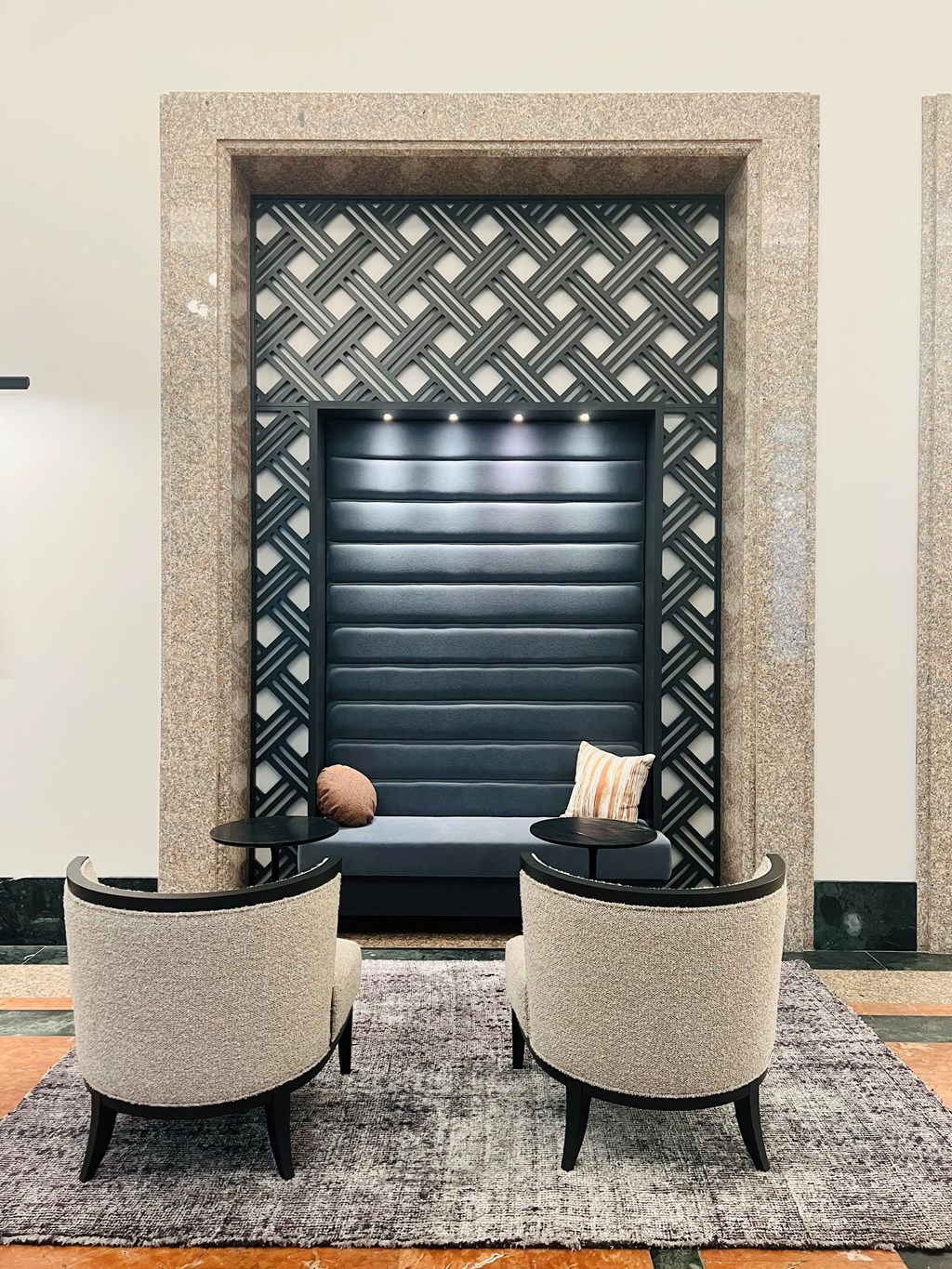 a living room with two chairs and a fireplace