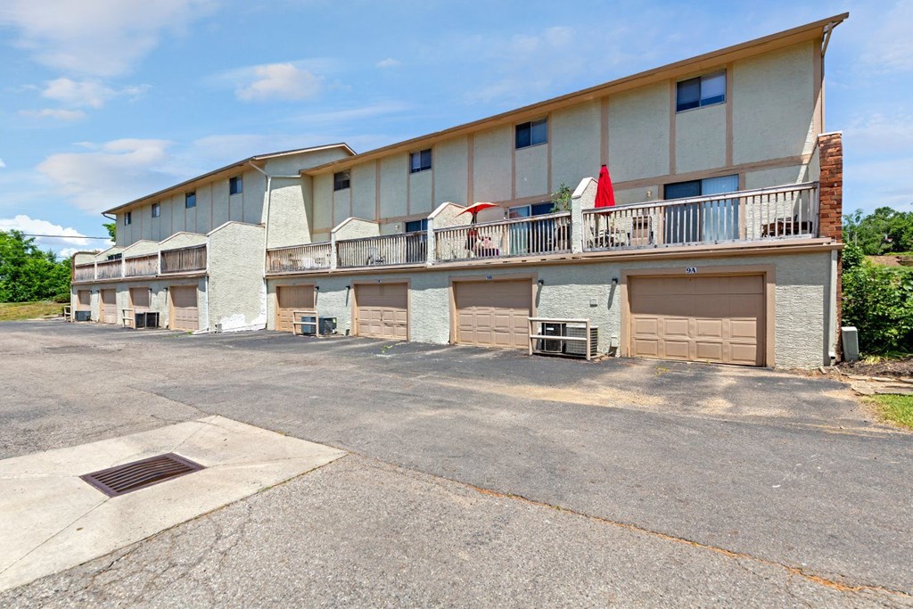 a building with two garages and a patio with a flag on it