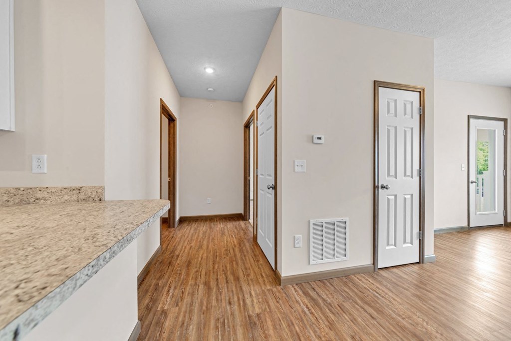 the living room and dining room of a house with wood flooring