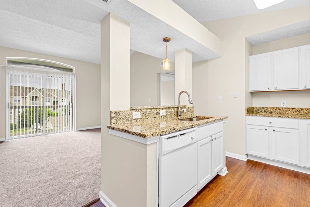a kitchen with white cabinets and a counter top