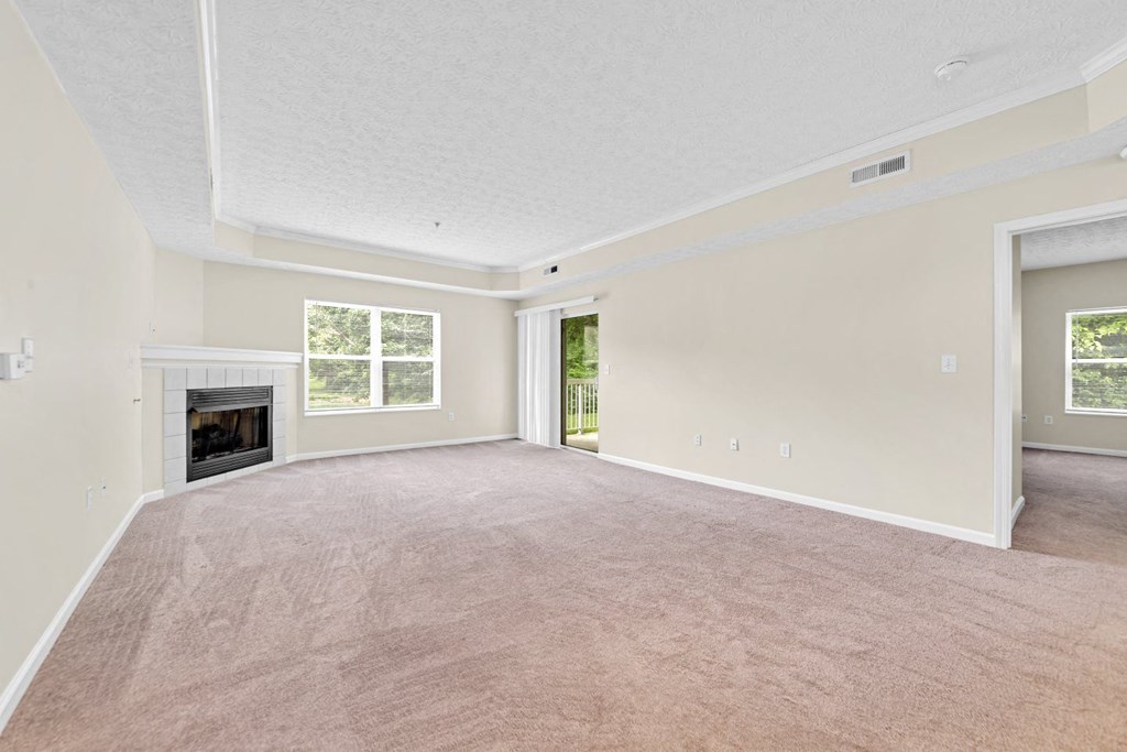 an empty living room with a fireplace