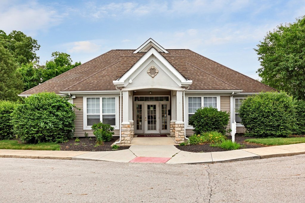 the front of a house with a sidewalk in front of it