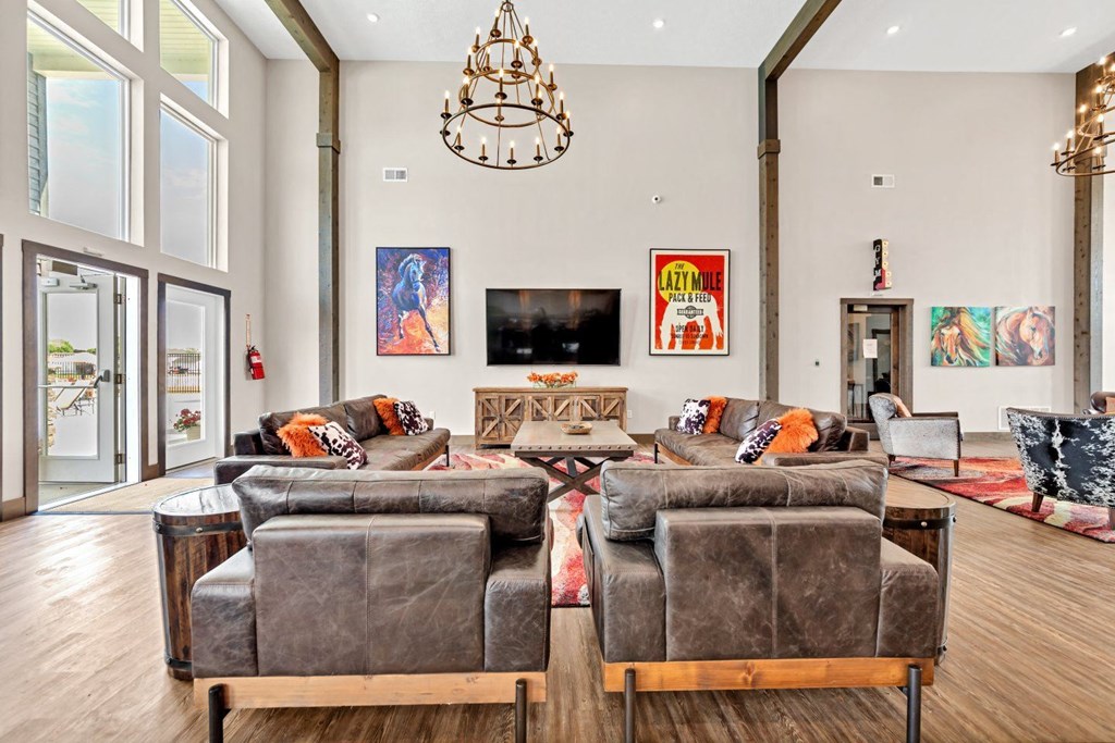 a living room with couches and chairs and a chandelier