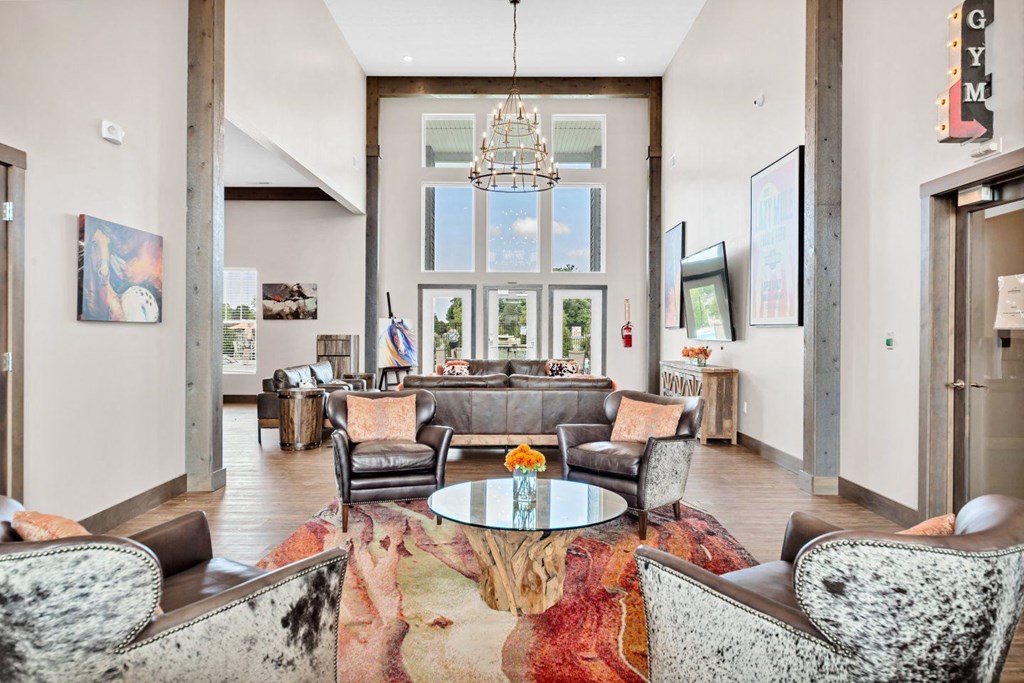 a living room with a couch and chairs and a chandelier