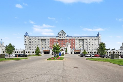 A large white building with a red roof and a blue roof.