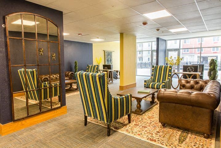 a lobby with couches and chairs and a table