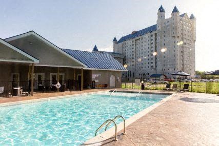a swimming pool with a large building in the background
