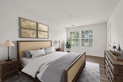 A bedroom with a large bed and a wooden nightstand.