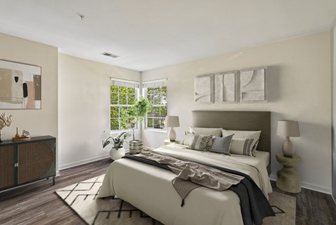 A bedroom with a large bed and a window.
