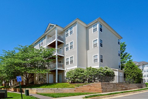 A large apartment building with a balcony on the second floor.