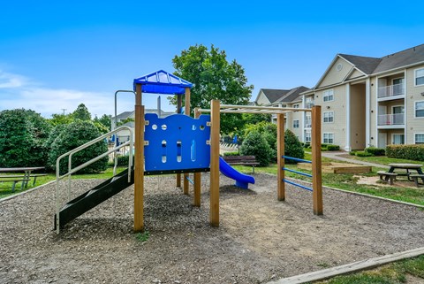 Childrens playground with blue play structure at Potomac Station Apartments, Virginia