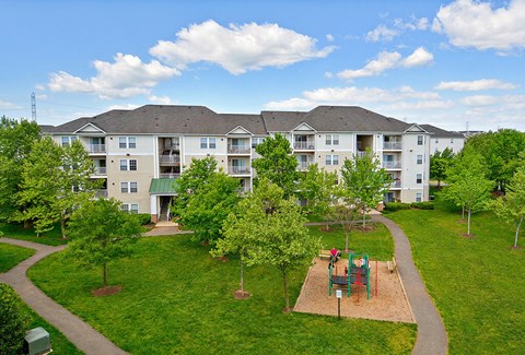Apartment complex with a playground in the front.