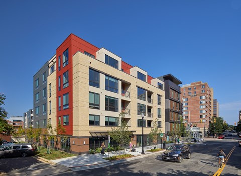 A red and beige building with a clear blue sky in the background.