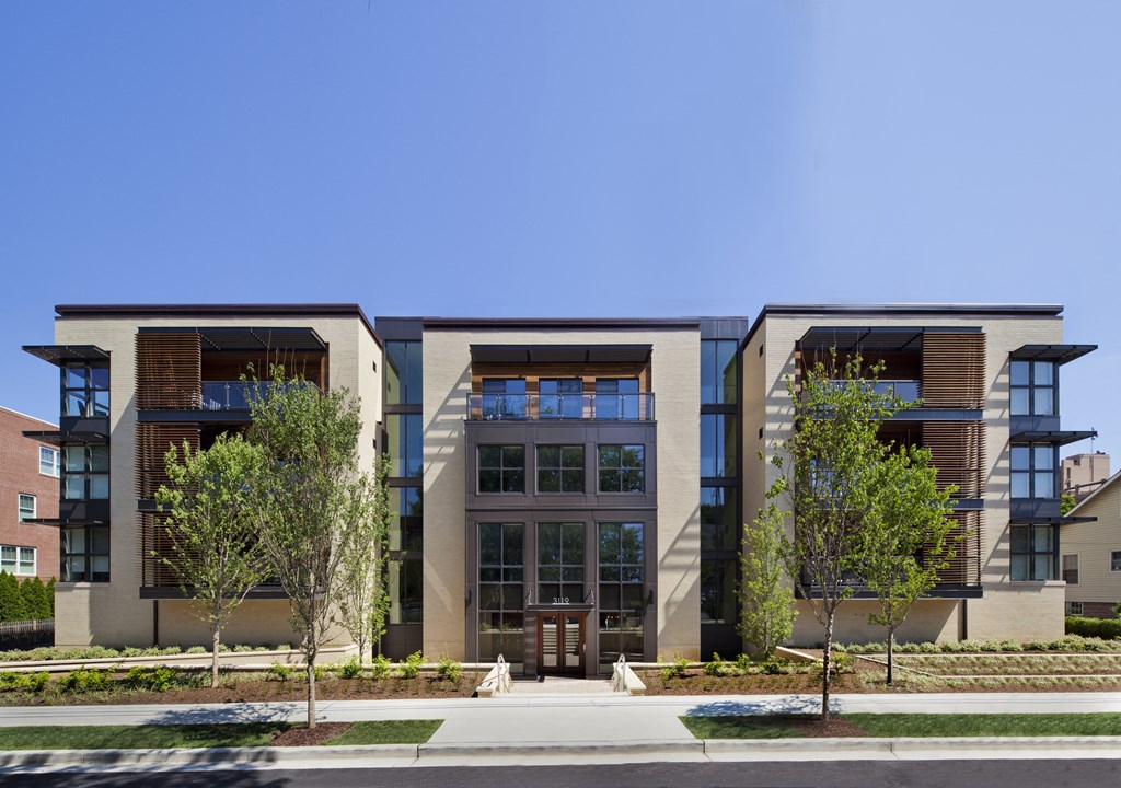 a group of buildings with trees in front of them