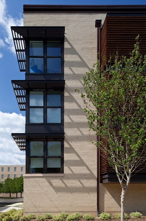 a tall tower on the side of a building with windows