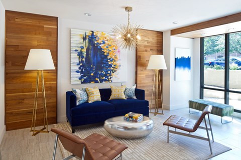 a living room with a blue couch and a gold
