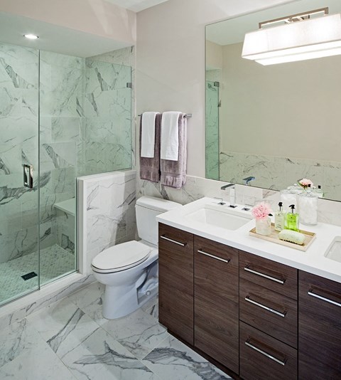 a bathroom with a toilet and a sink and a shower