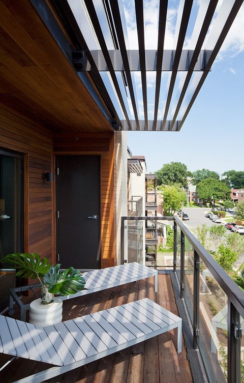 a small balcony with a table and chairs on it
