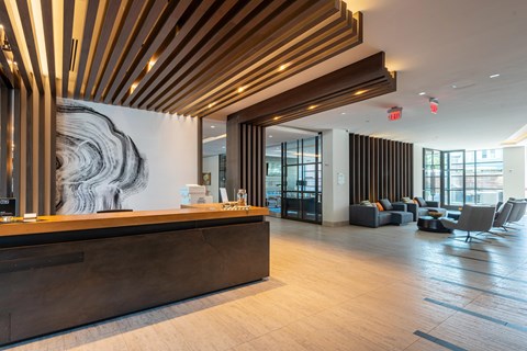 A reception area with a wooden ceiling and a large abstract painting on the wall.