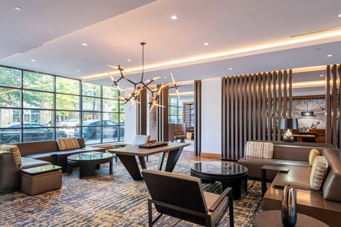 A modern living room with a large window and a chandelier.