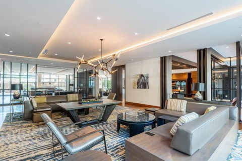 A modern living room with a large grey sofa and a wooden coffee table.