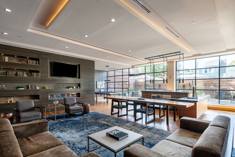 A modern living room with a fireplace and a large window.