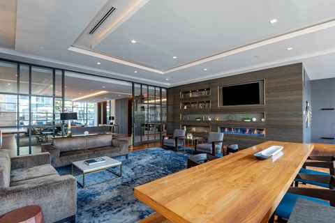 A modern living room with a wooden table and a television.