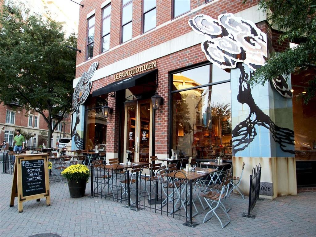the outside of a restaurant with tables and chairs