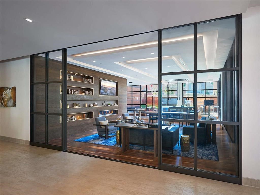 a large conference room with glass walls and a desk