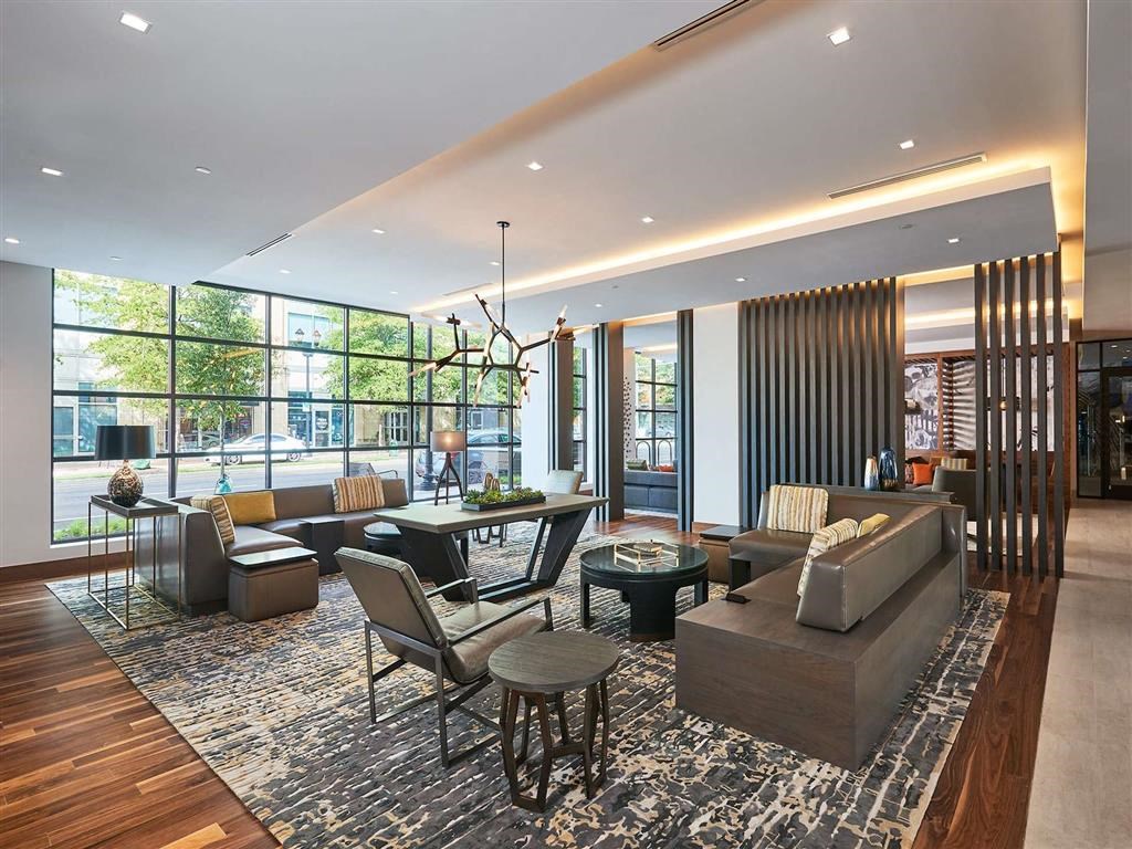 a living room with couches and chairs and a table