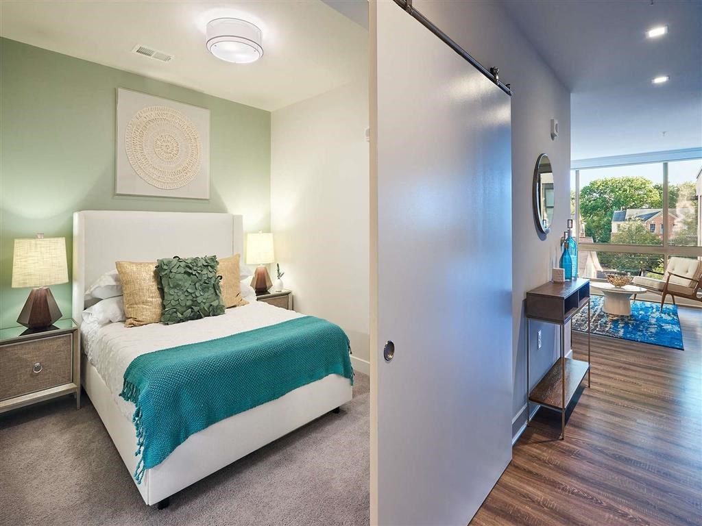 a bedroom with a bed and a door to a bathroom