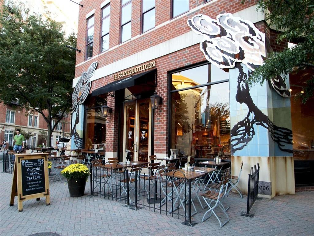 the outside of a restaurant with tables and chairs