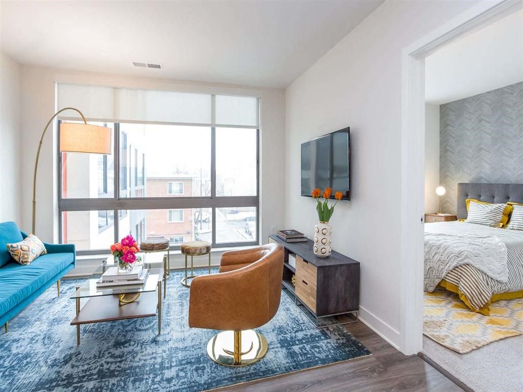 a bedroom with a bed and a couch and a tv