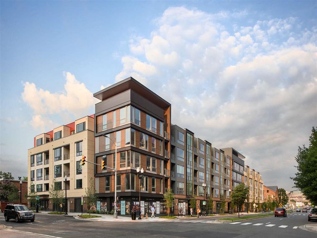 a rendering of an apartment building on a city street