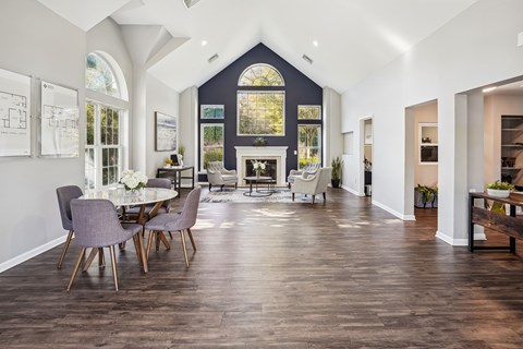 A dining room with a table and chairs.