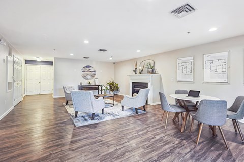 A modern living room with a fireplace and a dining table set up.