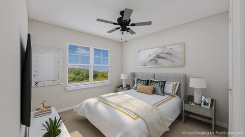 A bedroom with a large bed and a ceiling fan.