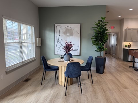 A dining room with a round table and chairs.