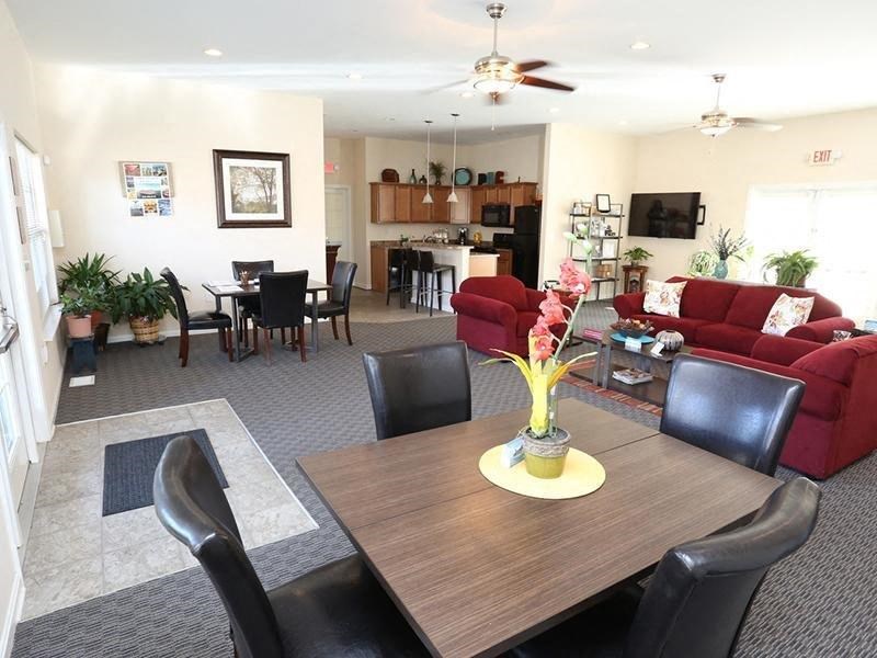 a living room and dining room with a table