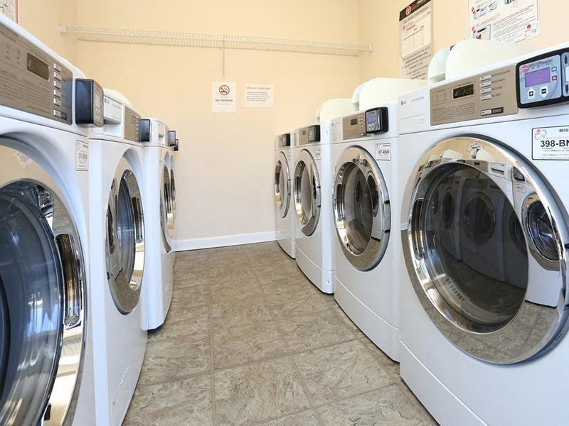 a row of washers and dryers in a laundry room