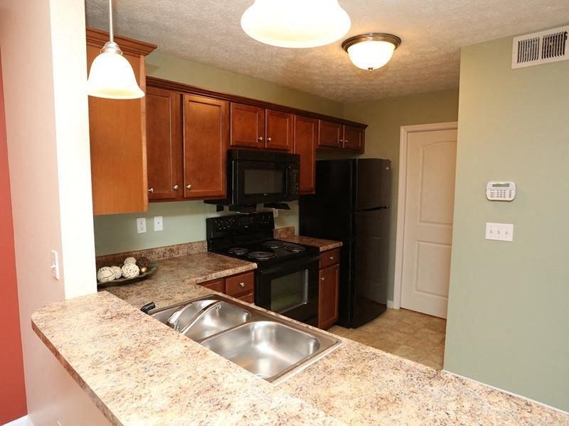 a kitchen with a sink a stove and a refrigerator