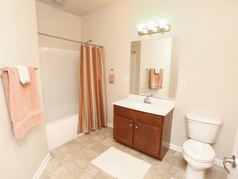 a bathroom with a toilet sink and a mirror