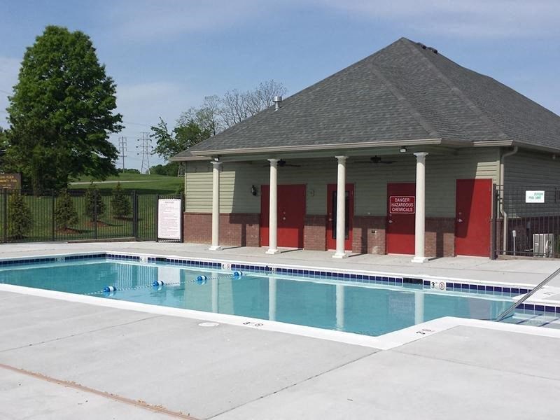 a swimming pool with a pavilion next to it