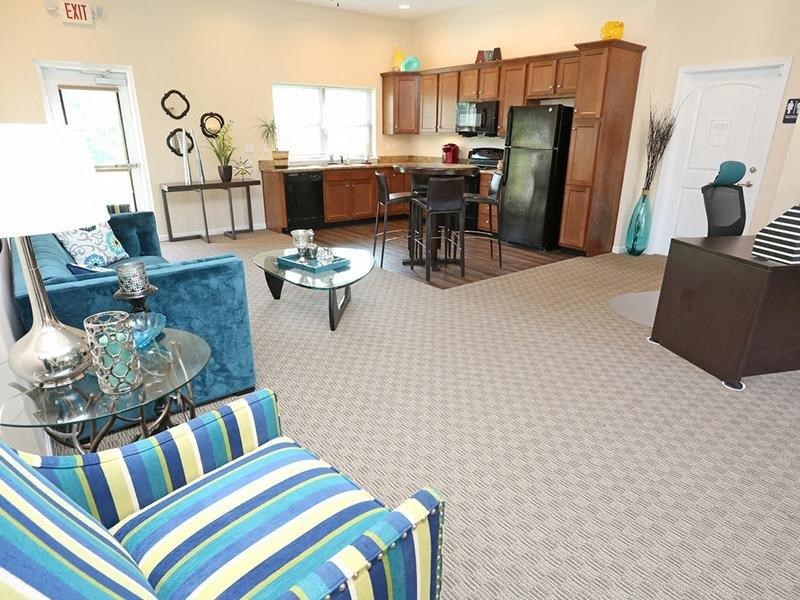 a living room and kitchen with a couch and a table