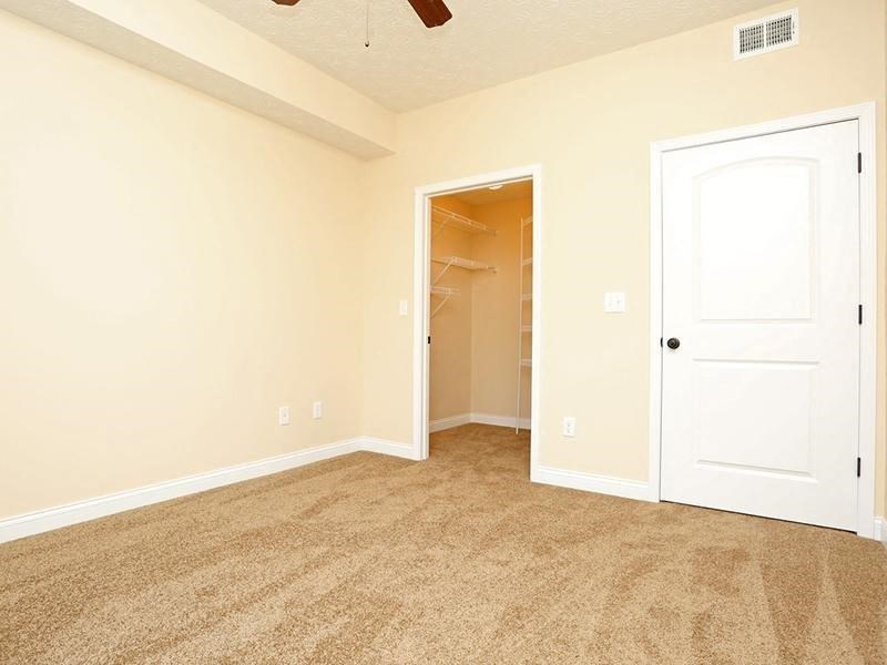an empty living room with a door to a closet