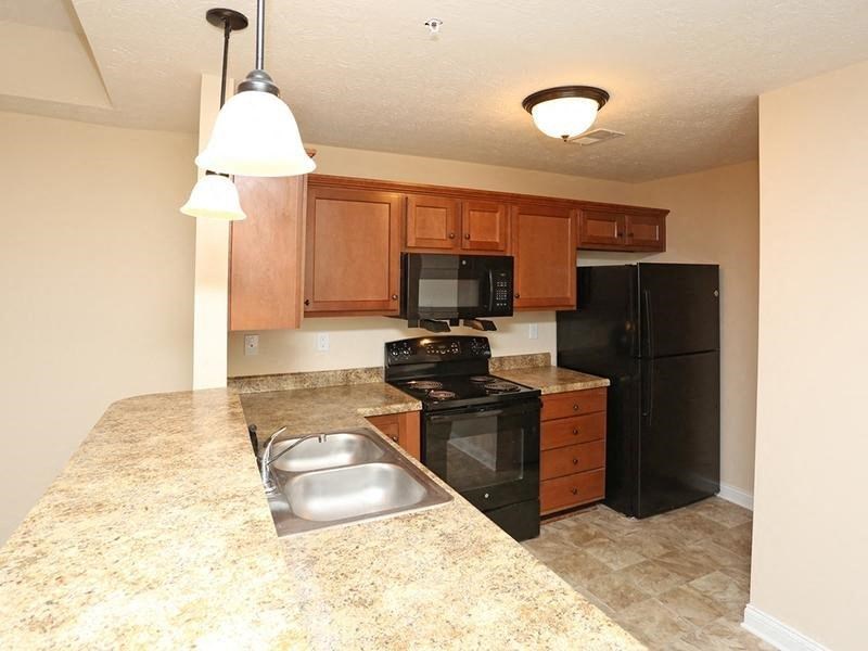 a kitchen with black appliances and granite counter tops