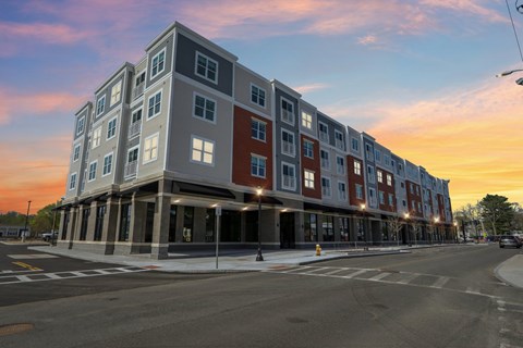 A modern apartment building with a street in front.